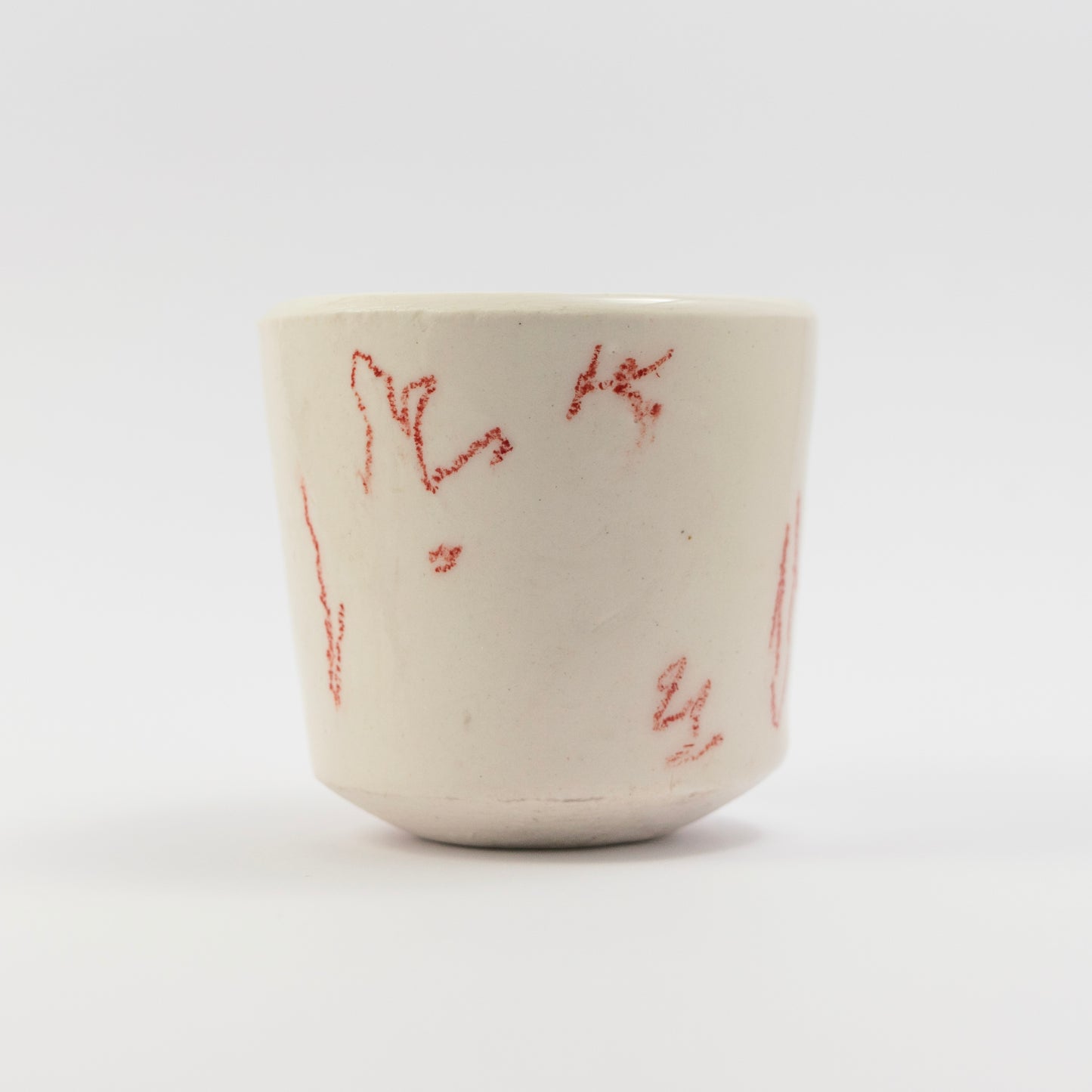 Side view showing more scattered red doodle marks in different orientations.