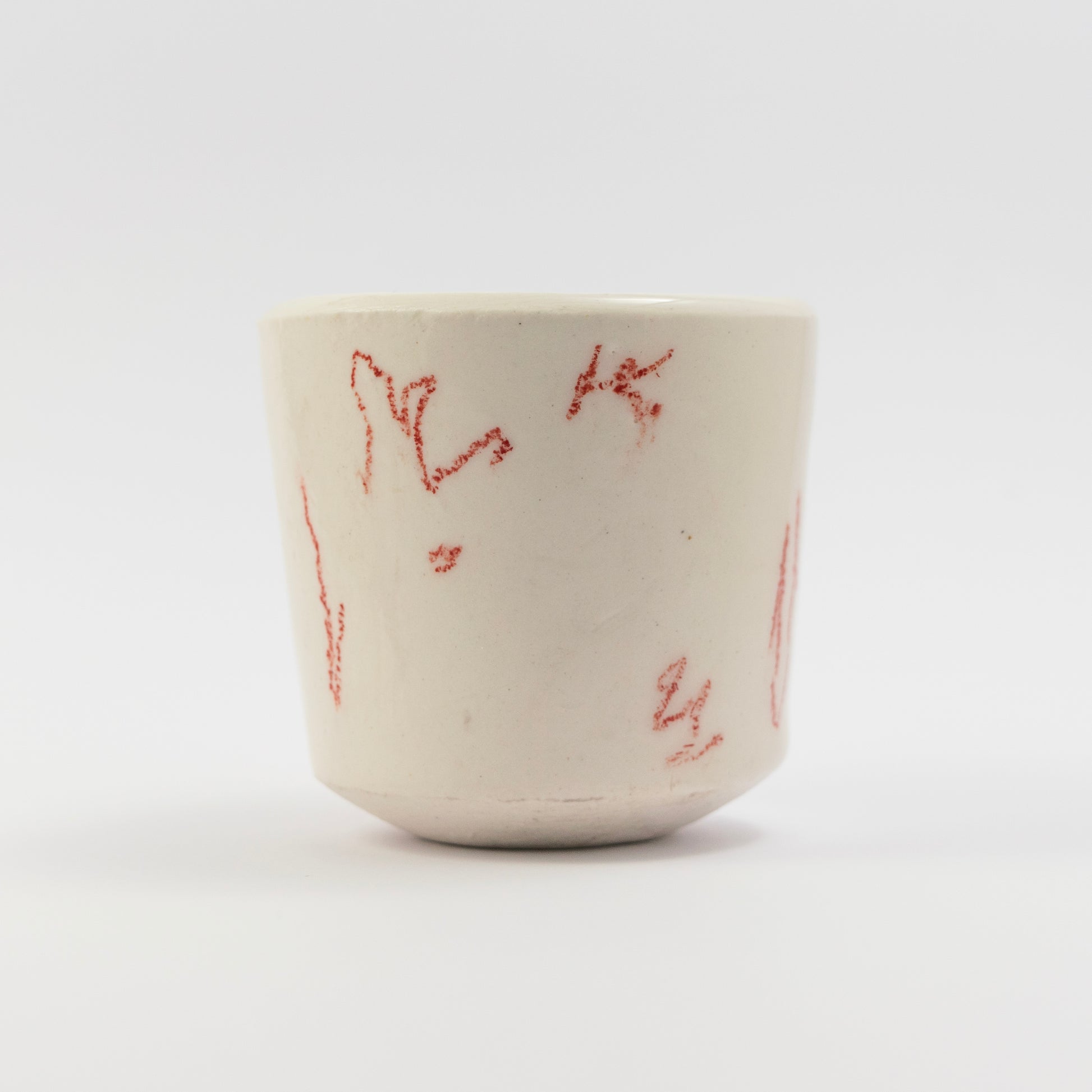 Side view showing more scattered red doodle marks in different orientations.