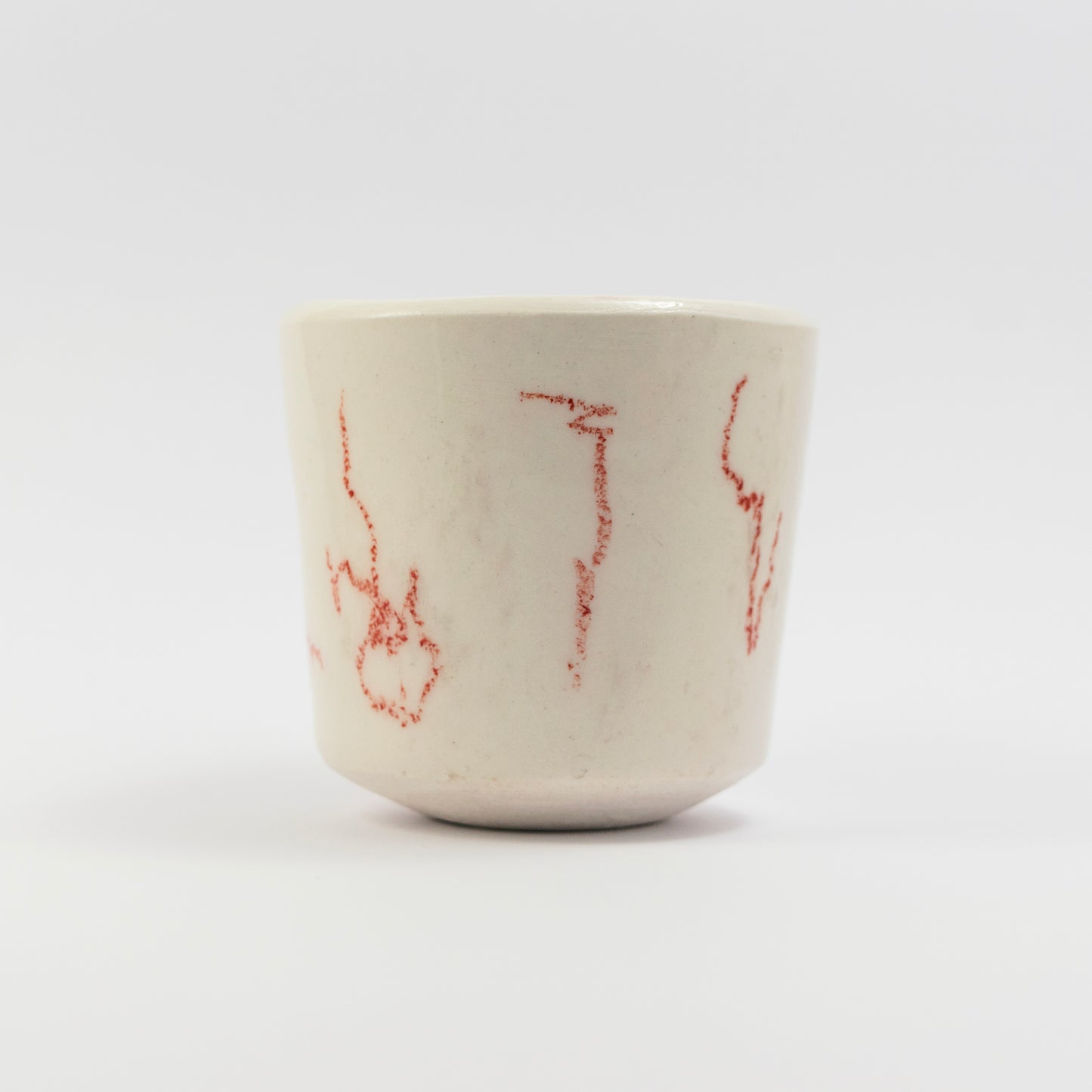 Side view showing more scattered red doodle marks in different orientations.