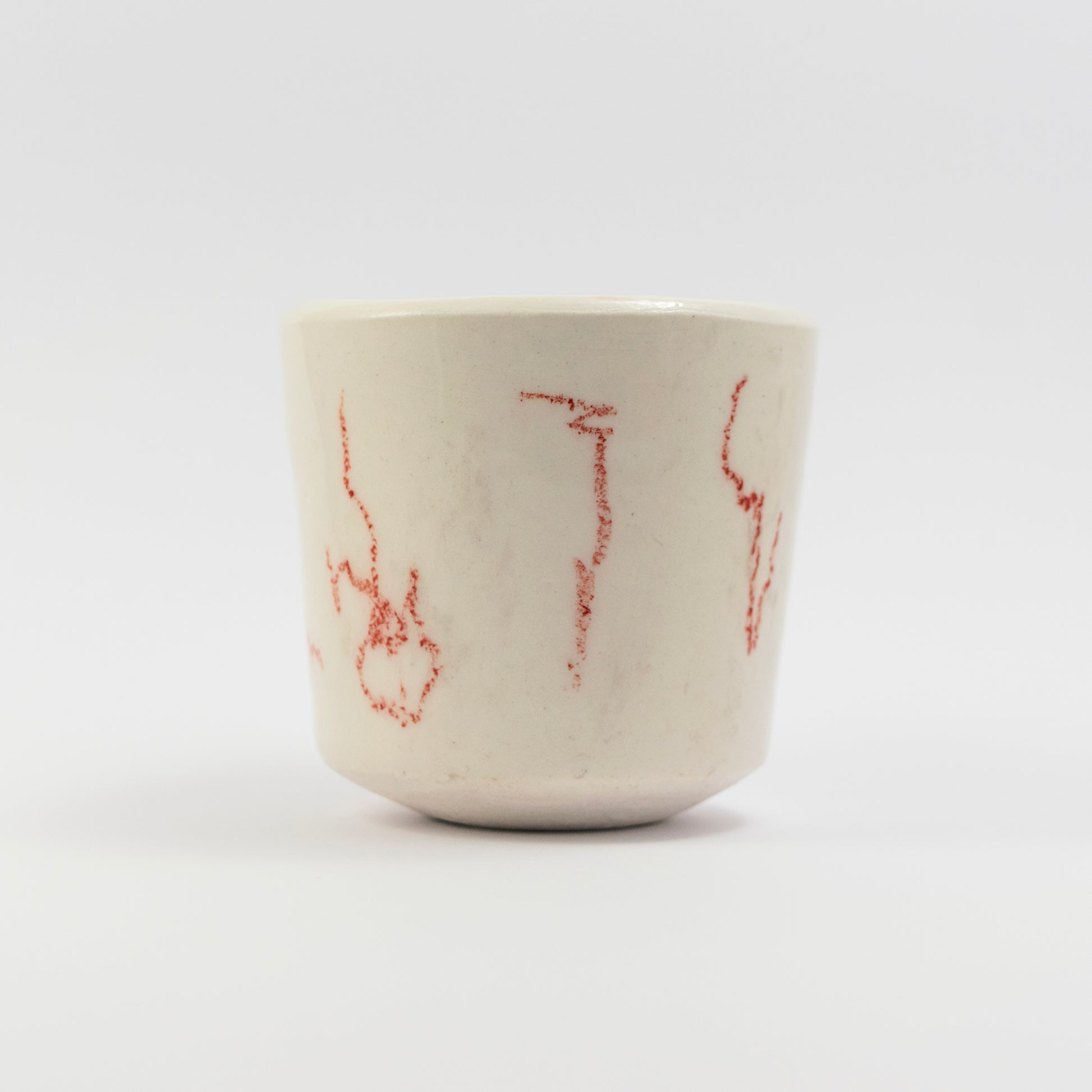 Side view showing more scattered red doodle marks in different orientations.