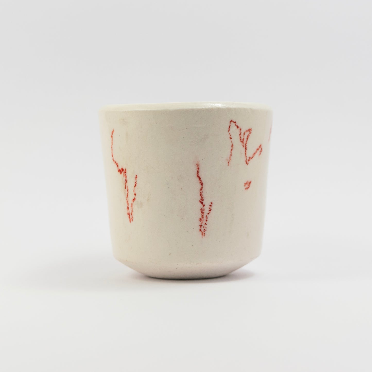 Side view showing more scattered red doodle marks in different orientations.