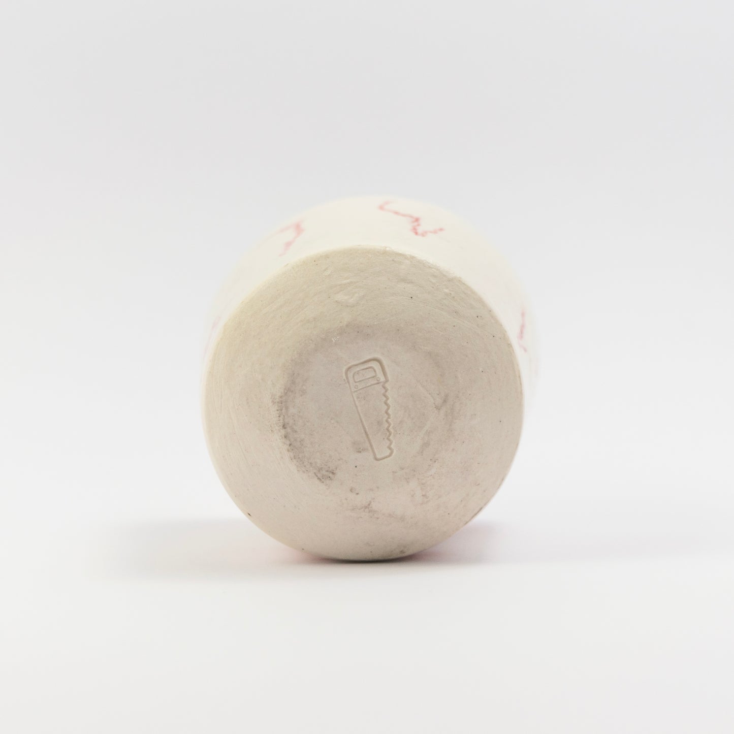 Bottom of the cup showing an impressed saw stamp mark.