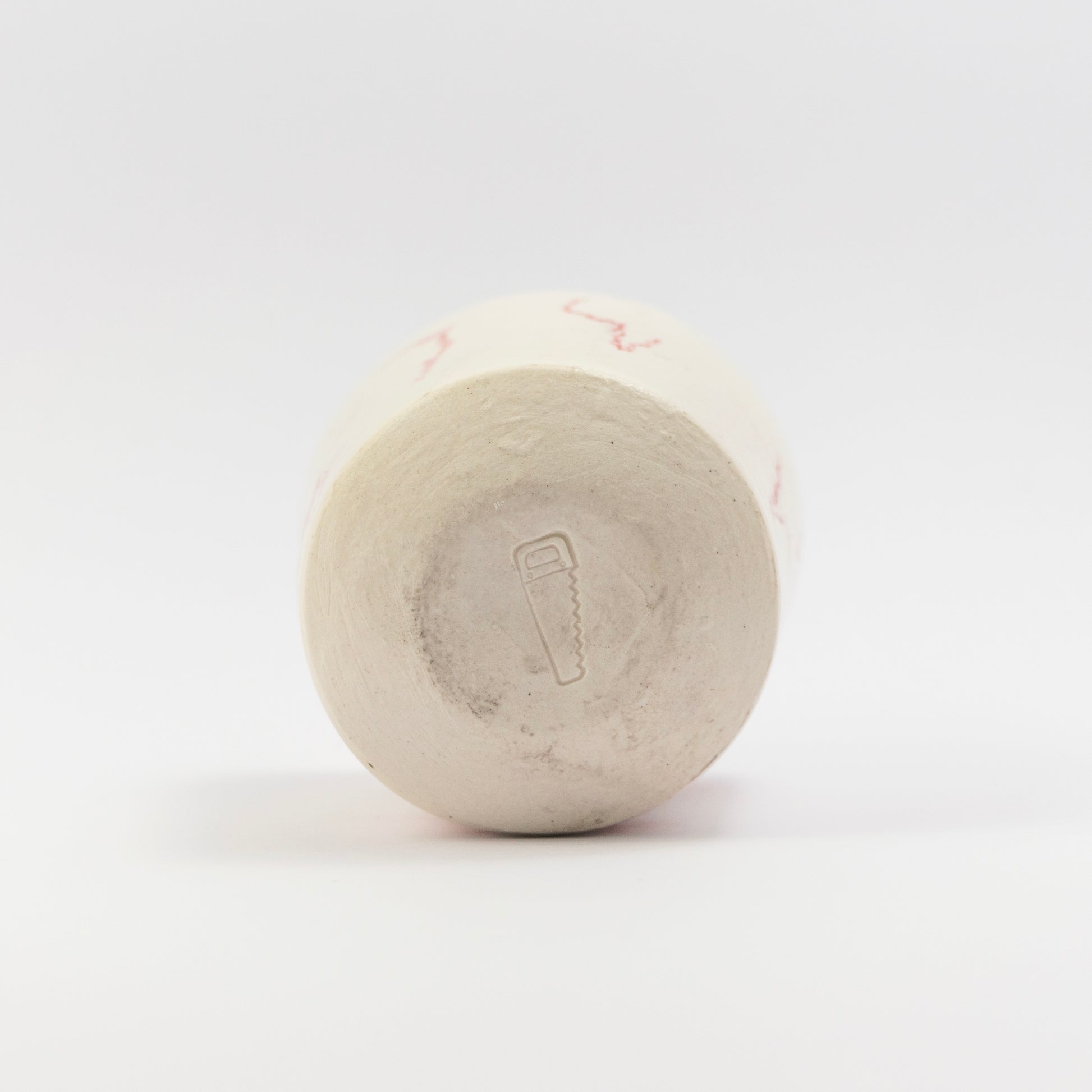 Bottom of the cup showing an impressed saw stamp mark.