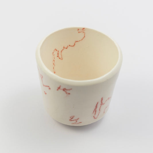 Top-down angle showing the inside of the cup with a red squiggle along the inner rim.