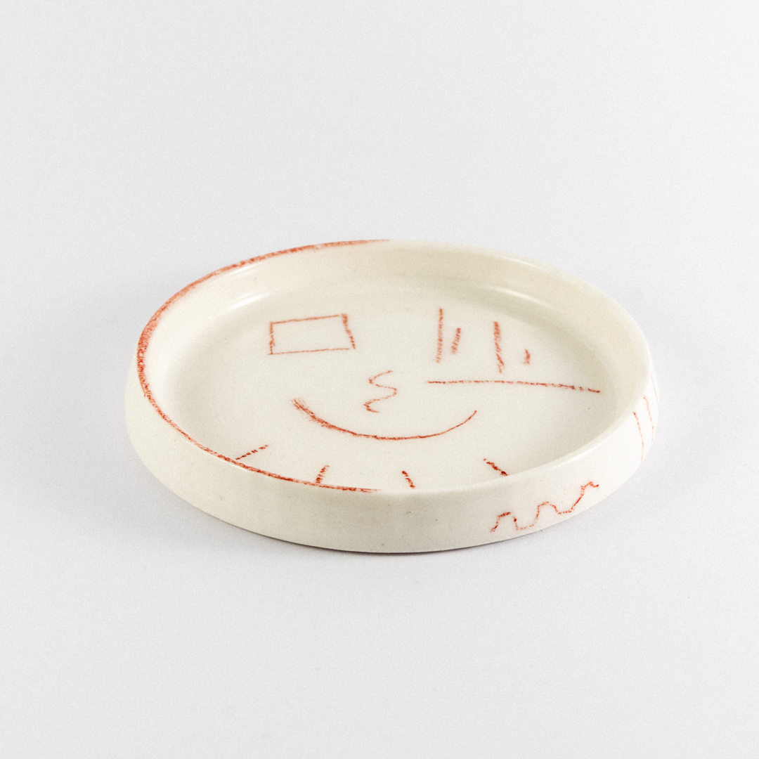 Porcelain trinket tray with rend hand drawn doodles.
