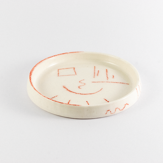 Porcelain trinket tray with rend hand drawn doodles.